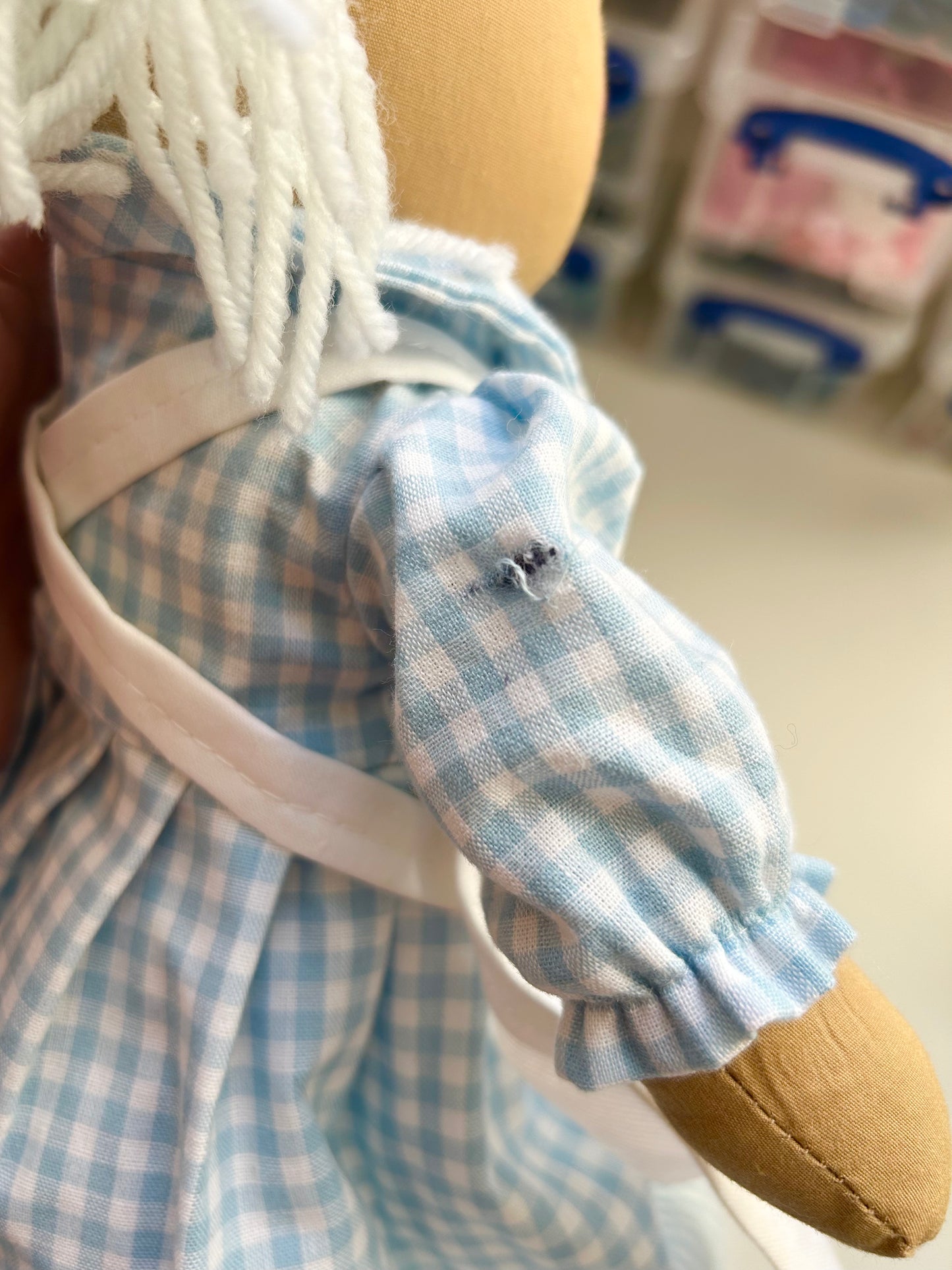 SECOND-READ DESCRIPTION. Nancy Nurse embroidered with the name Maisie